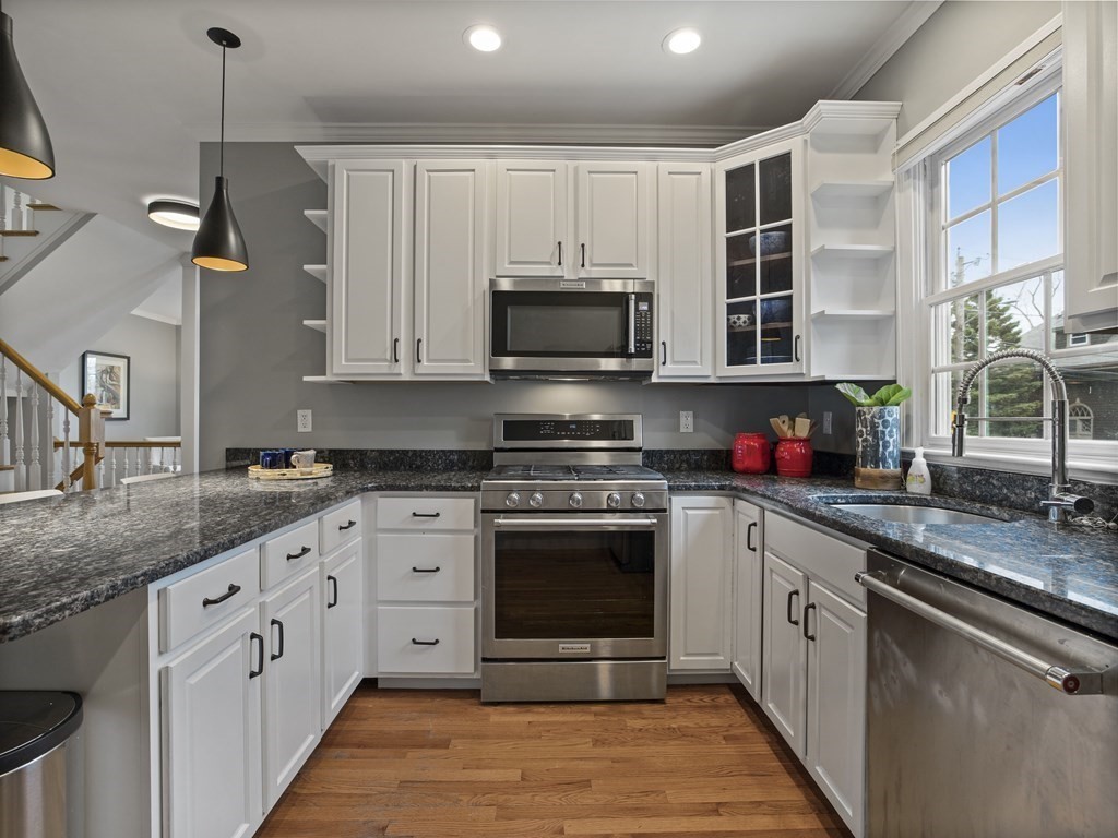 44 A Orchardhill Road, Unit A Boston, MA 02130 - Photo 8 of 37 a kitchen with stainless steel appliances granite countertop a stove a sink and a microwave
