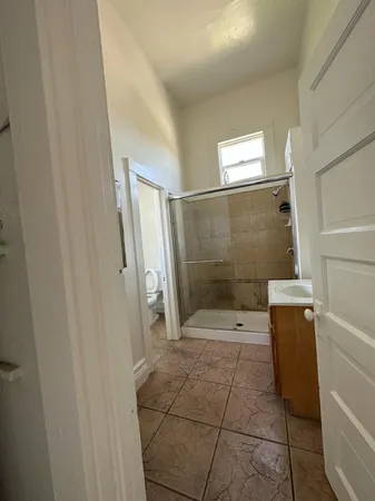 a bathroom with a glass shower door