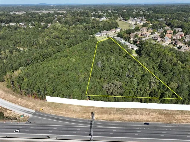an aerial view of a residential houses with city view