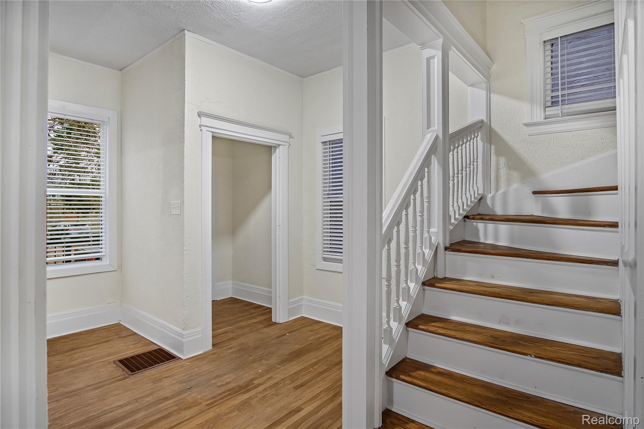427 Melbourne Street Detroit, MI 48202 - Photo 3 of 29 Staircase featuring wood finished floors and a textured ceiling
