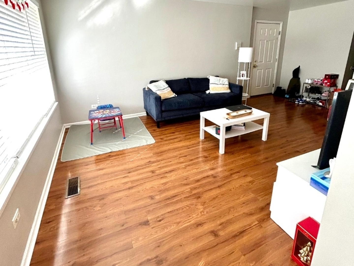 978 North Village Drive, Unit 2 Round Lake Beach, IL 60073 - Photo 5 of 7 a living room with furniture and a wooden floor
