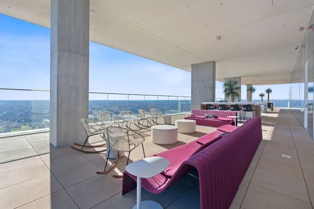 a living room with furniture a rug and a painting on the wall