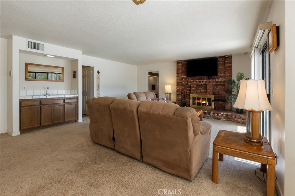 17656 Mockingbird Hill Circle Riverside, CA 92504 - Photo 11 of 49 a living room with furniture and a flat screen tv
