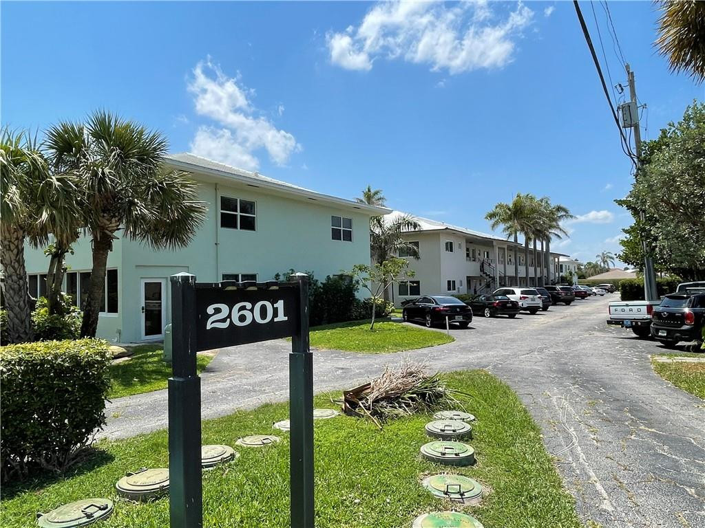 2601 South Ocean Boulevard, Unit 9 Boca Raton, FL 33432 - Photo 1 of 33 a front view of a house with garden and sitting area