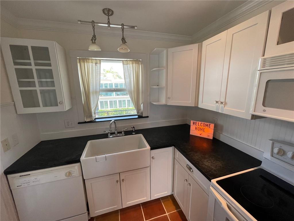 2601 South Ocean Boulevard, Unit 9 Boca Raton, FL 33432 - Photo 15 of 33 a kitchen that has a sink and a stove in it