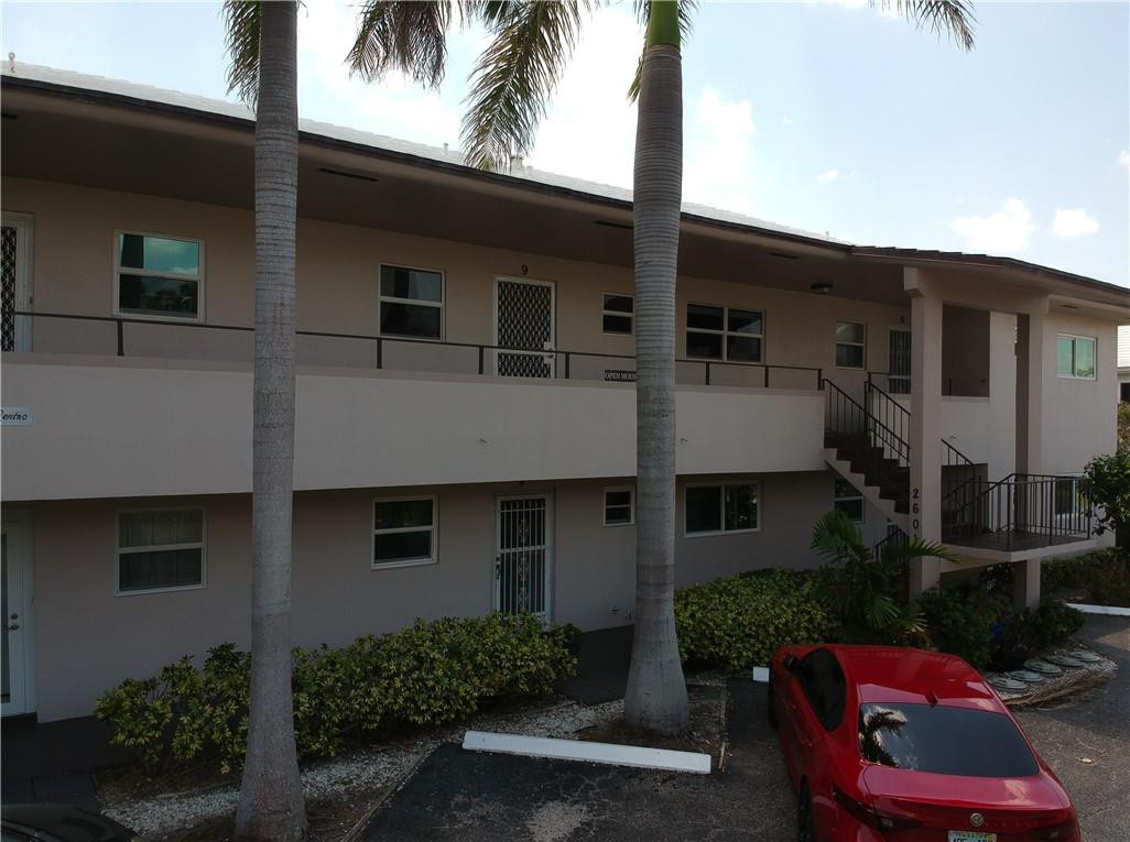 2601 South Ocean Boulevard, Unit 9 Boca Raton, FL 33432 - Photo 25 of 33 a front view of a house with yard and furniture
