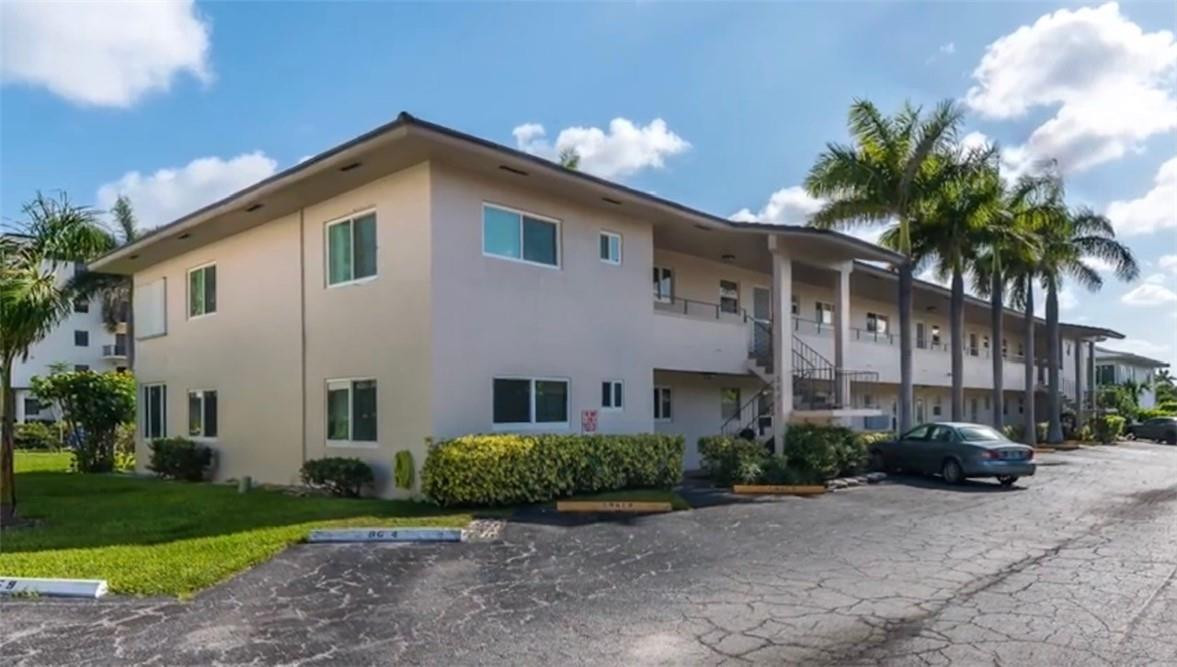 2601 South Ocean Boulevard, Unit 9 Boca Raton, FL 33432 - Photo 3 of 33 a view of a white house with a yard and plants