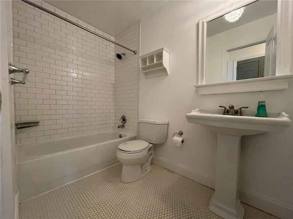 2601 South Ocean Boulevard, Unit 9 Boca Raton, FL 33432 - Photo 8 of 33 a white toilet sitting next to a bathroom sink