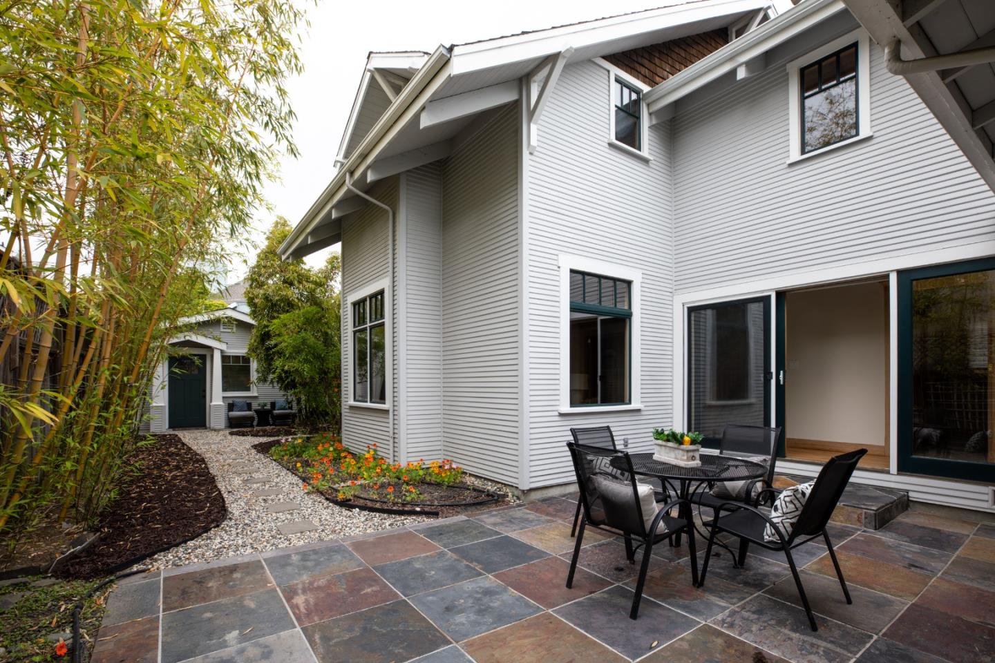 345 Berkeley Way Santa Cruz, CA 95062 - Photo 25 of 39 a view of a patio with table and chairs and potted plants