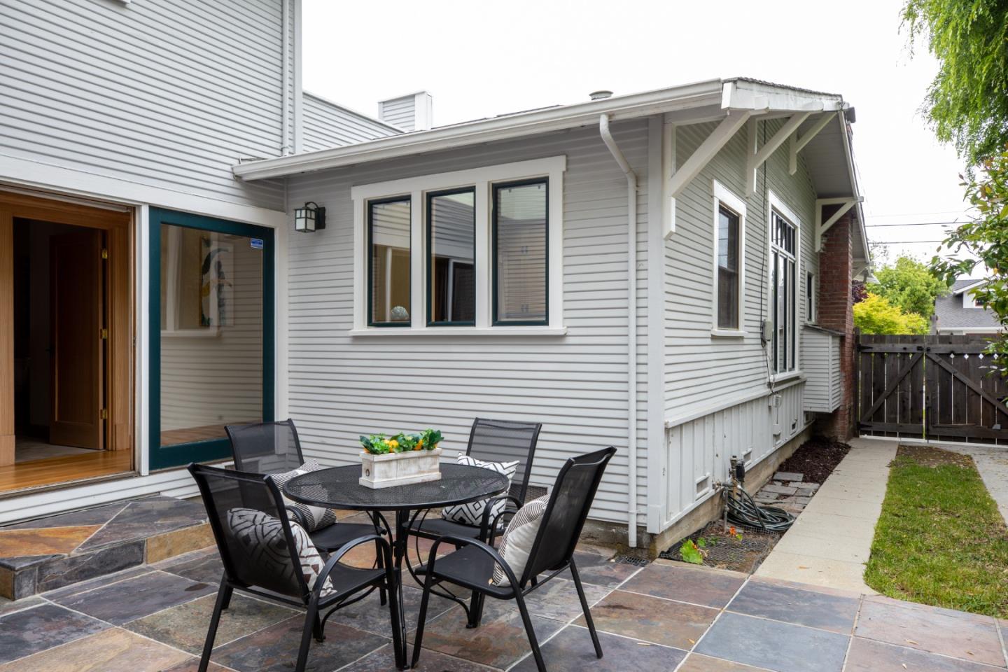 345 Berkeley Way Santa Cruz, CA 95062 - Photo 27 of 39 a view of a patio with table and chairs and wooden fence