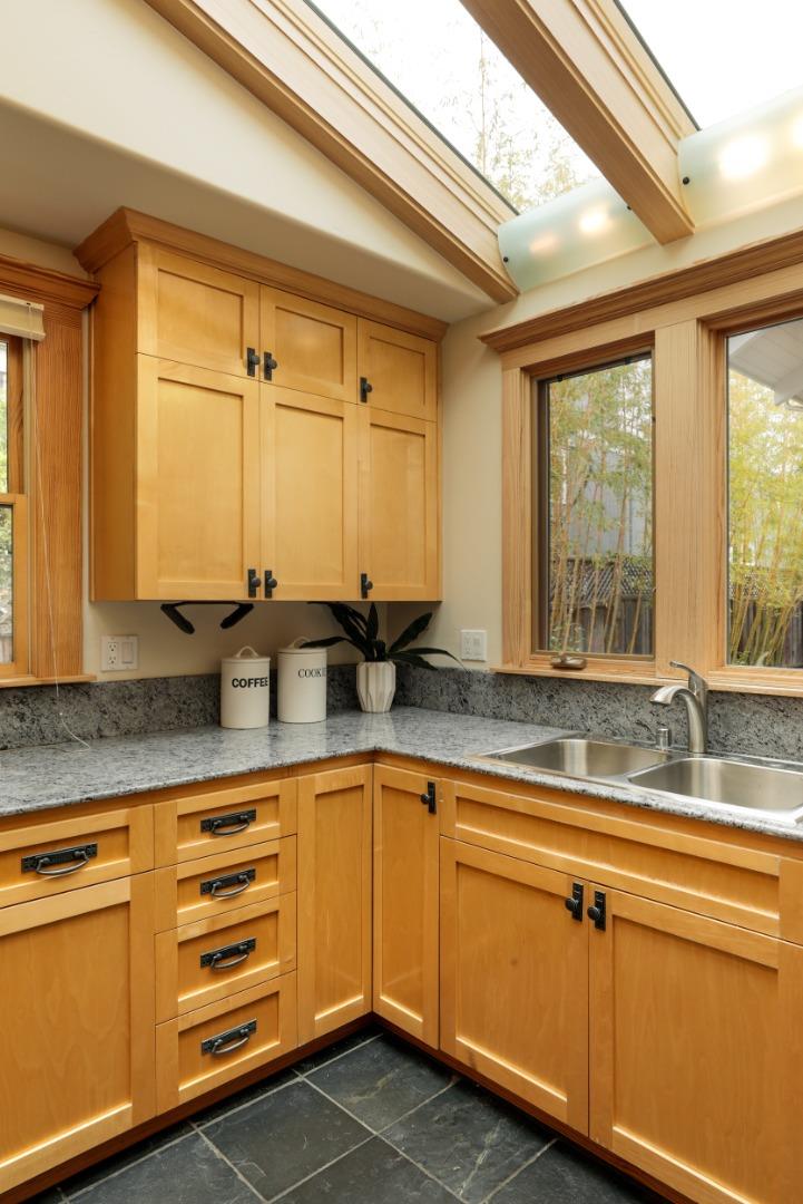 345 Berkeley Way Santa Cruz, CA 95062 - Photo 8 of 39 a kitchen with granite countertop a sink and white cabinets