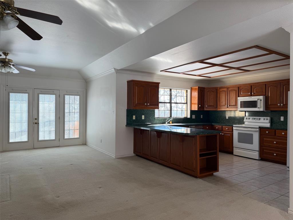150 Timberidge Lake Road Graham, TX 76450 - Photo 8 of 25 a large kitchen with stainless steel appliances granite countertop a stove and a sink