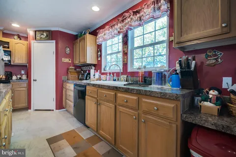 a kitchen with stainless steel appliances kitchen island granite countertop a sink stove and cabinets