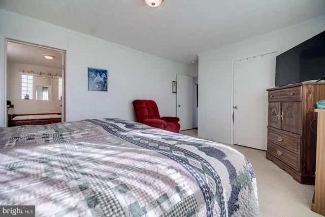 a spacious bathroom with a granite countertop sink and a mirror