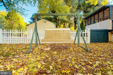 a view of a house with a yard and tree s