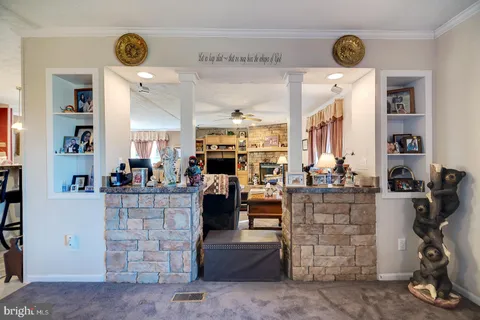 a living room with furniture a flat screen tv and a clock