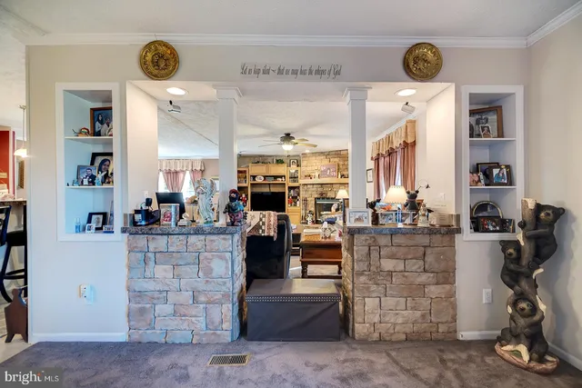 a living room with furniture a flat screen tv and a clock