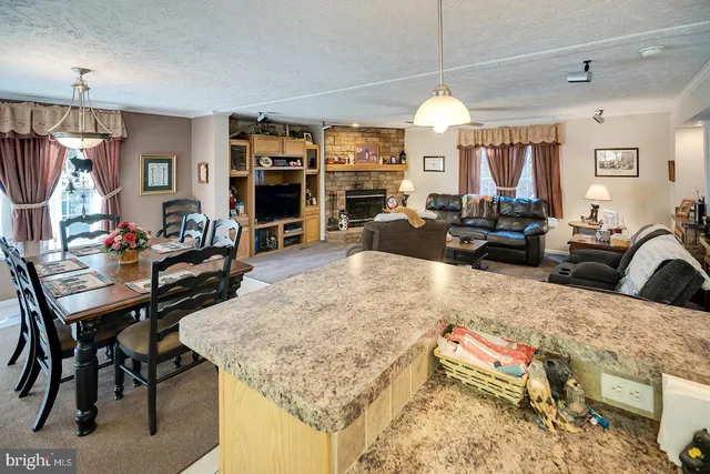 a living room with furniture a chandelier and a flat screen tv