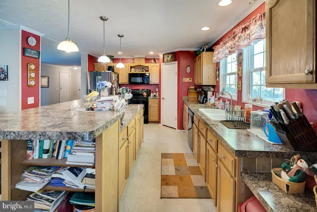 a open kitchen with stainless steel appliances granite countertop a sink stove and refrigerator