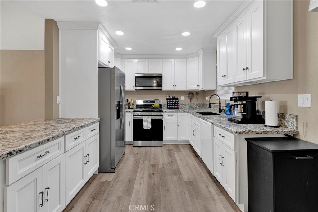 15471 Washoan Road Apple Valley, CA 92307 - Photo 11 of 38 a large kitchen with stainless steel appliances granite countertop a stove a sink and a refrigerator