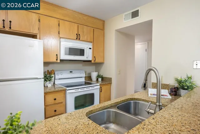 a kitchen with a stove microwave and sink