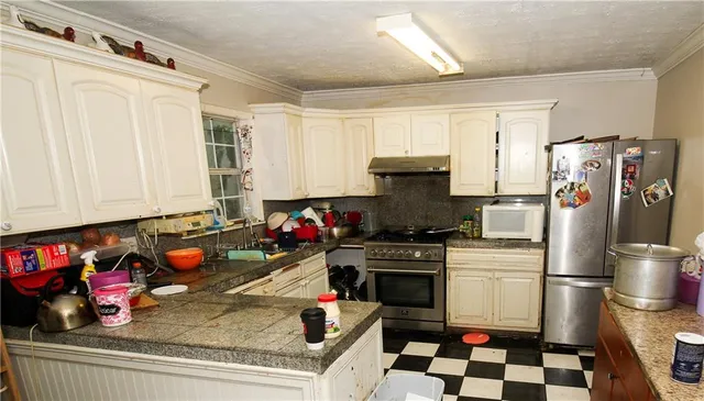a kitchen with a refrigerator a stove a sink and a cabinets