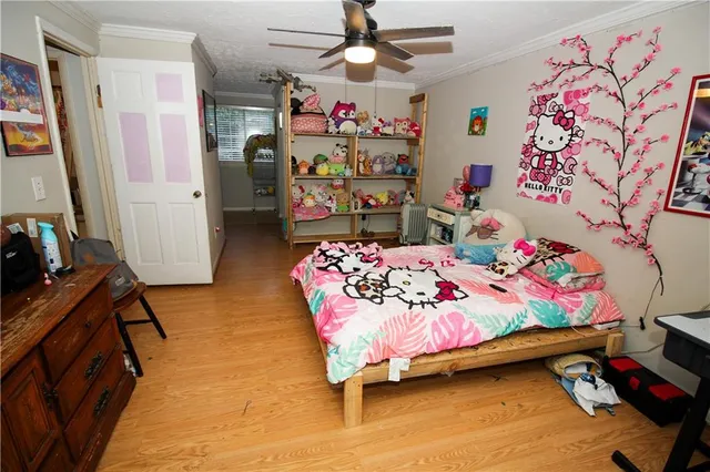 a bedroom with a bed and a dresser in it