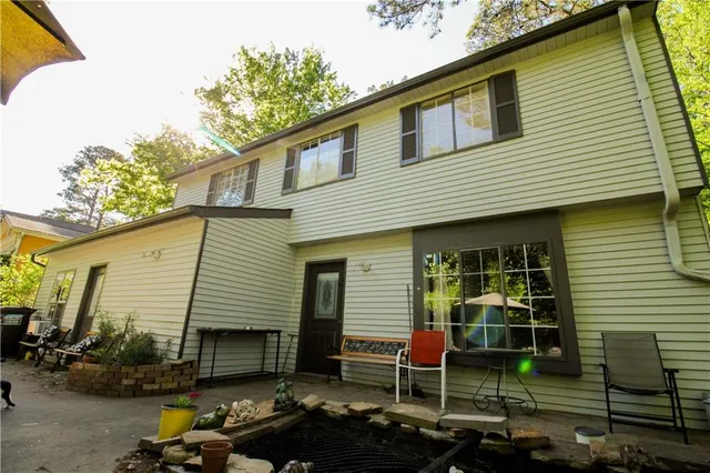a backyard of a house with table and chairs