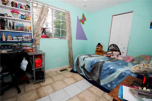 a bedroom with bed and a window