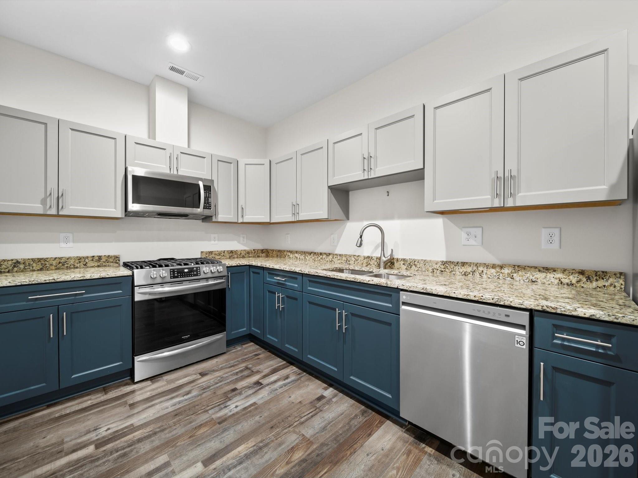 1421 Hamilton Crossroads Road Marshville, NC 28103 - Photo 16 of 29 a kitchen with granite countertop cabinets stainless steel appliances and a sink