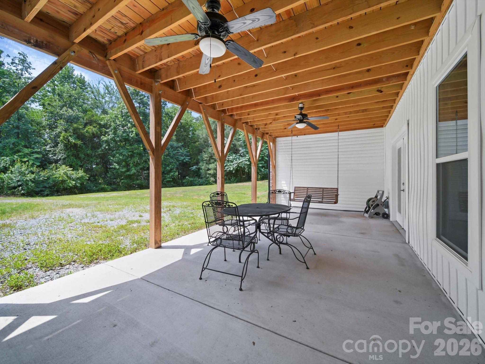 1421 Hamilton Crossroads Road Marshville, NC 28103 - Photo 17 of 29 a patio with yard glass top table and chairs