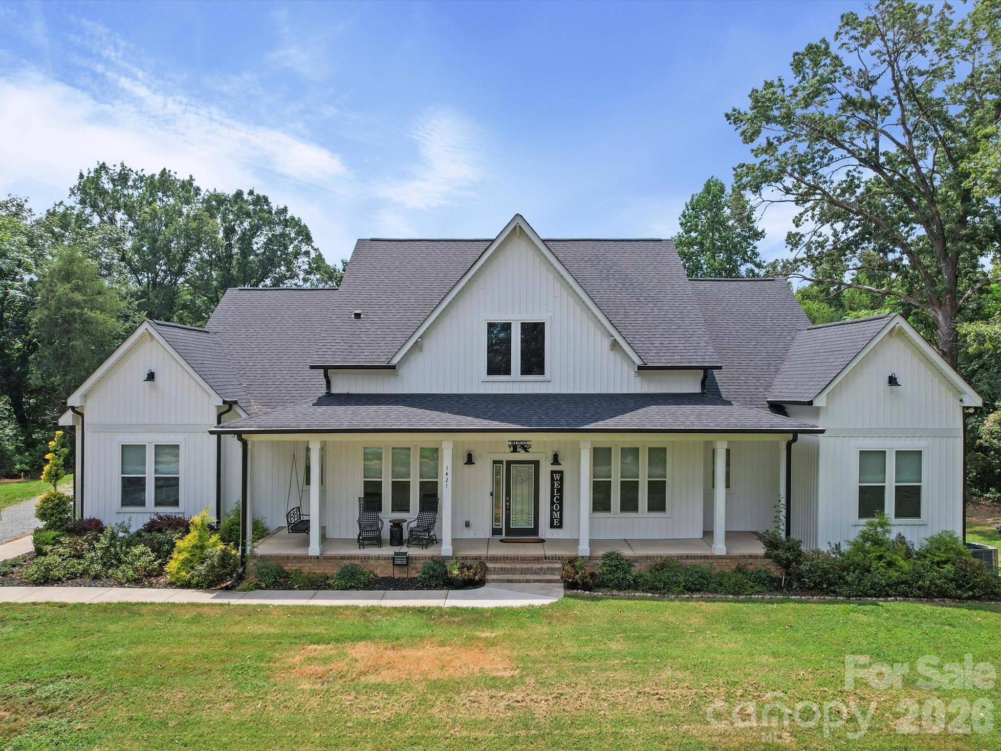 1421 Hamilton Crossroads Road Marshville, NC 28103 - Photo 2 of 29 a front view of a house with a yard table and chairs