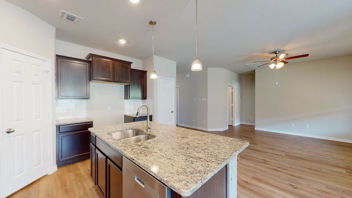 429 Creekfall Road Burnet, TX 78611 - Photo 6 of 28 Kitchen island with ample counter space connects seamlessly to an open-plan living area.