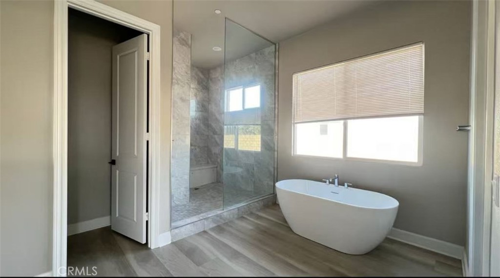 12925 Davona Dale Road Apple Valley, CA 92308 - Photo 12 of 14 a bathroom with a white tub shower and sink