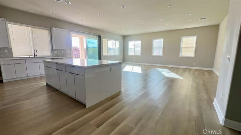 12925 Davona Dale Road Apple Valley, CA 92308 - Photo 6 of 14 a kitchen with stainless steel appliances granite countertop wooden floors and white walls