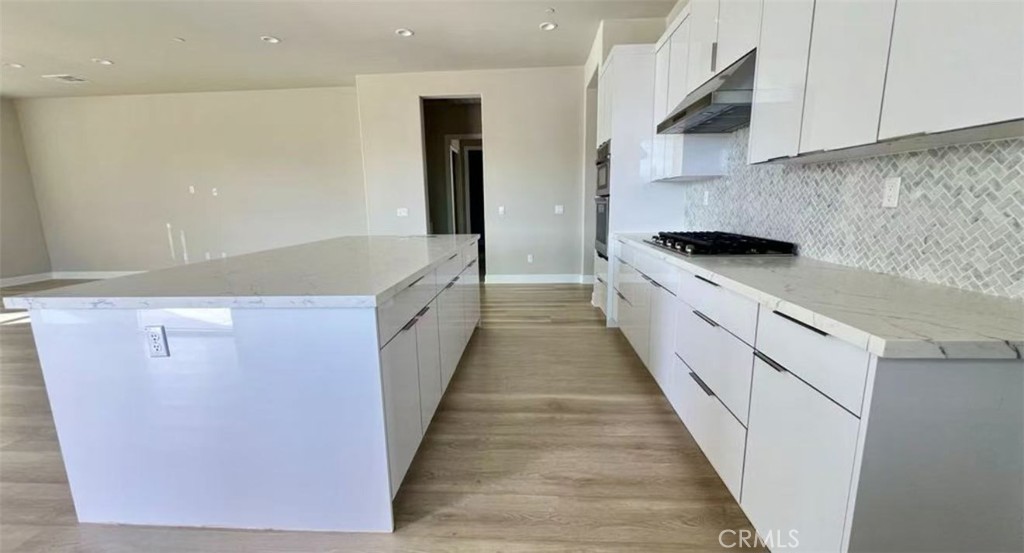 12925 Davona Dale Road Apple Valley, CA 92308 - Photo 7 of 14 a large kitchen with stainless steel appliances granite countertop a refrigerator a sink and a stove
