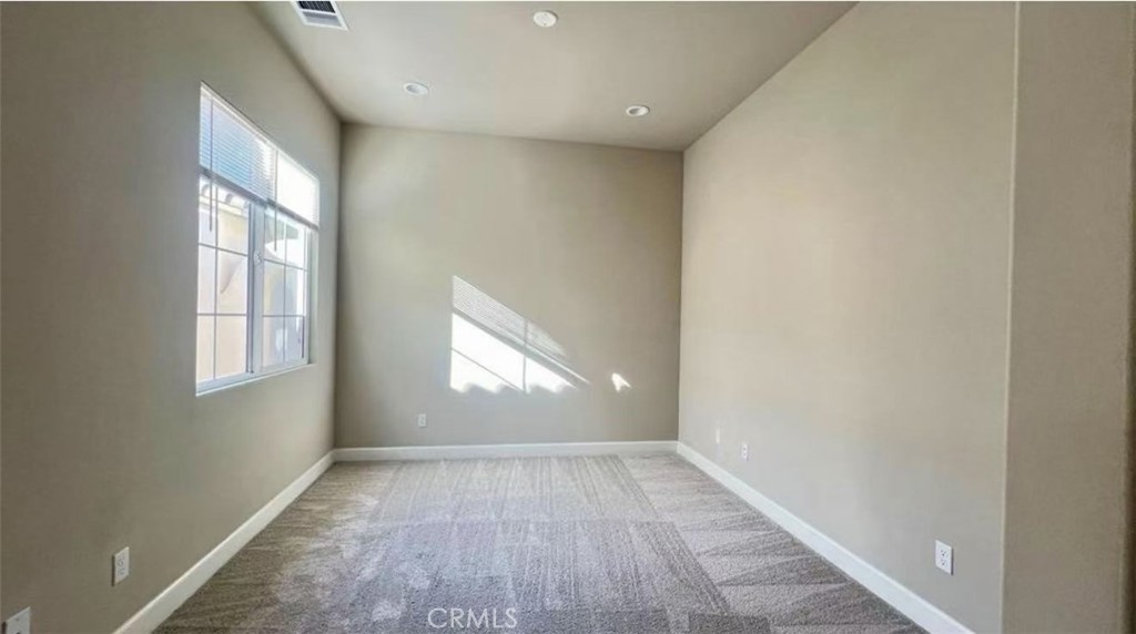 12925 Davona Dale Road Apple Valley, CA 92308 - Photo 10 of 14 an empty room with wooden floor and windows