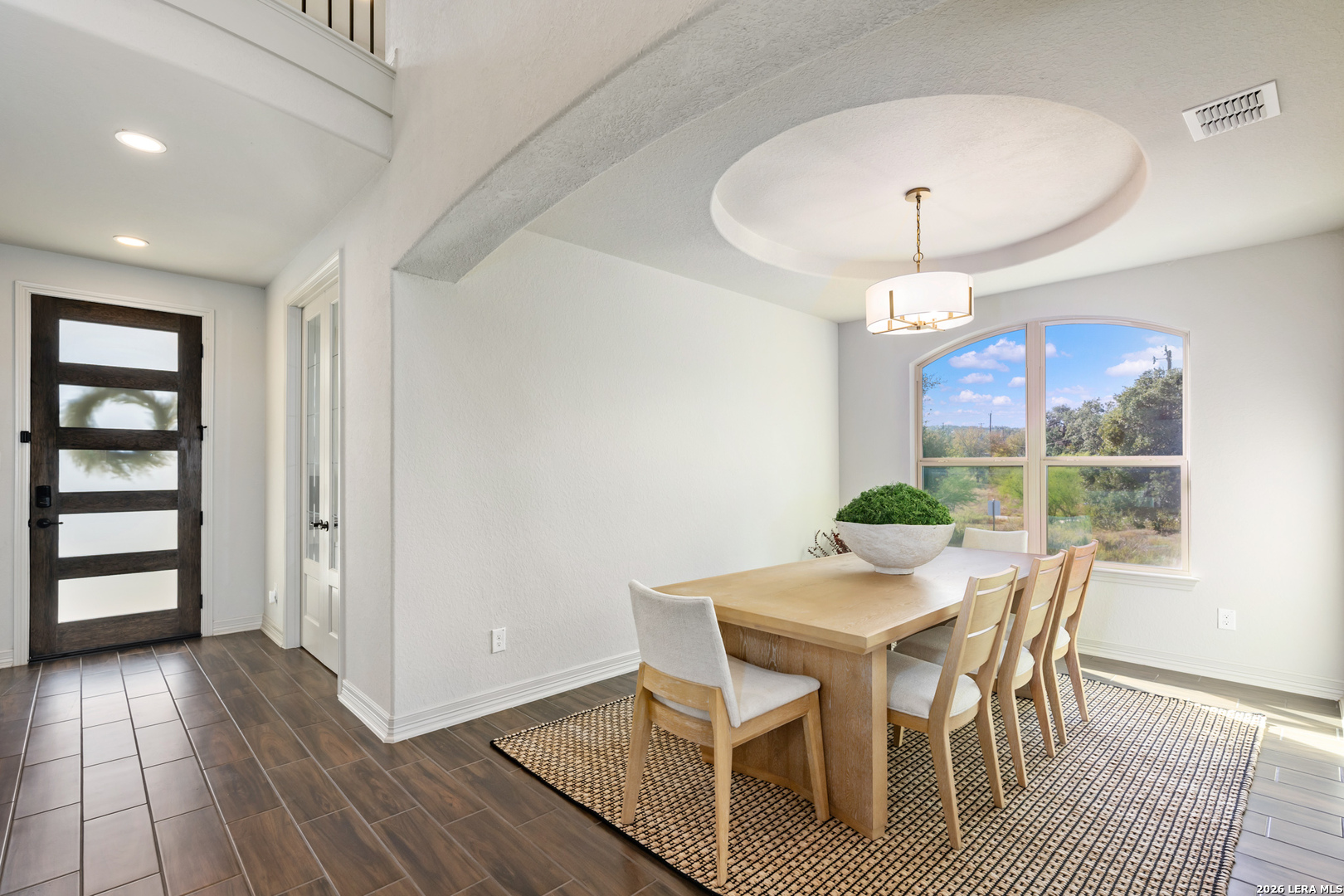 8527 Nichols Rim Boerne, TX 78015 - Photo 12 of 33 a view of a dining room with furniture and wooden floor
