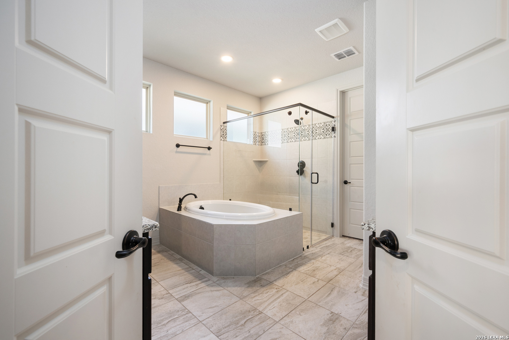 8527 Nichols Rim Boerne, TX 78015 - Photo 20 of 33 a spacious bathroom with a tub shower sink and mirror