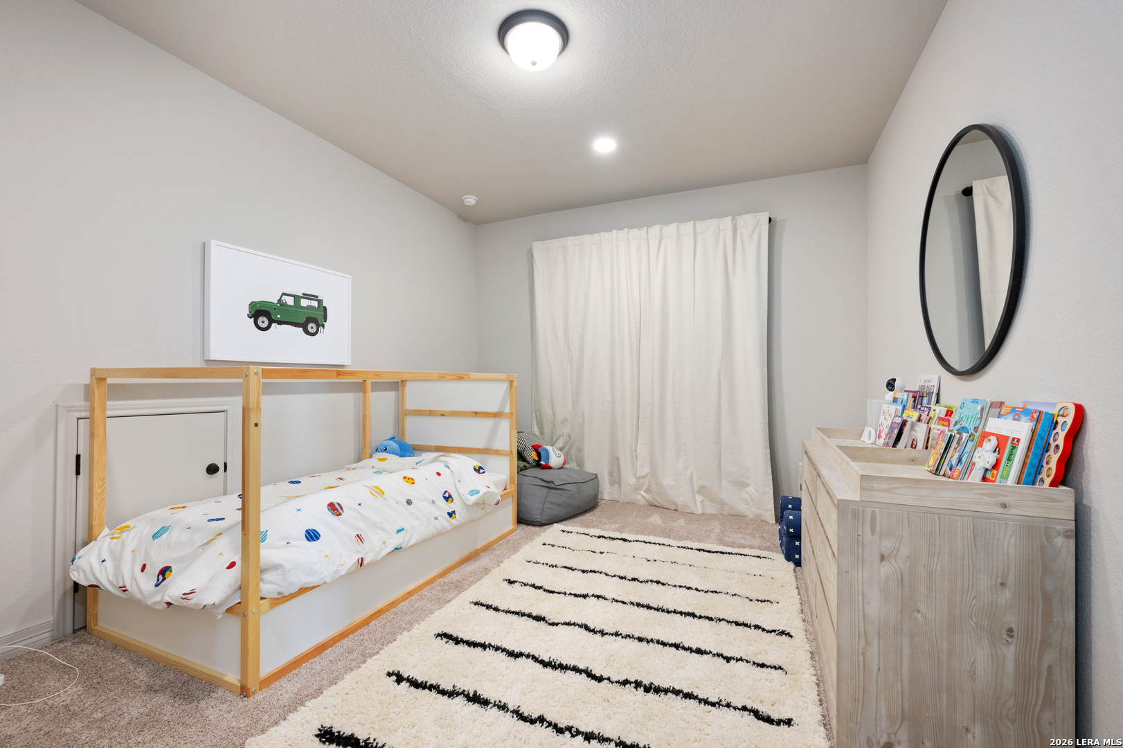 8527 Nichols Rim Boerne, TX 78015 - Photo 30 of 33 a bedroom with a bed a mirror and dresser