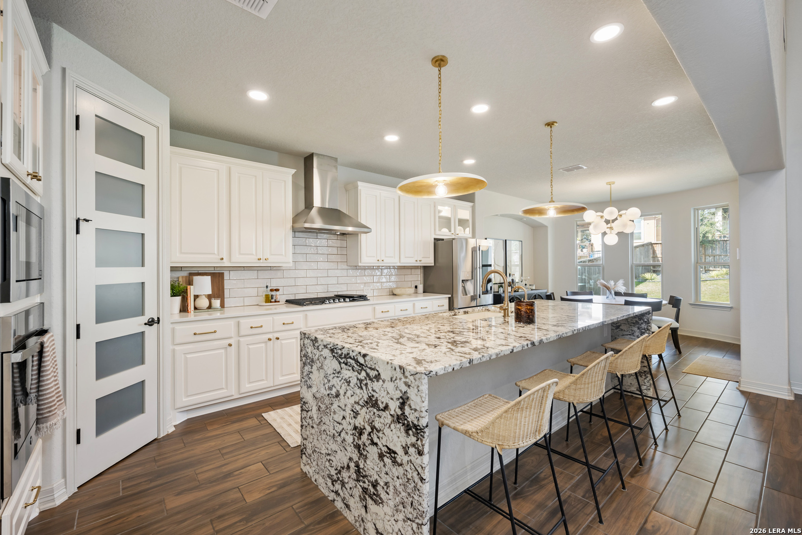 8527 Nichols Rim Boerne, TX 78015 - Photo 9 of 33 a large kitchen with kitchen island a large island in it