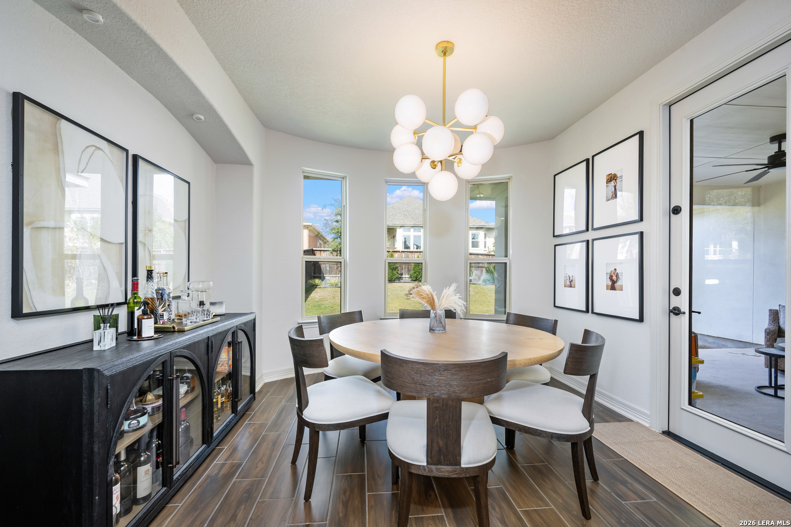 8527 Nichols Rim Boerne, TX 78015 - Photo 10 of 33 a view of a dining room with furniture window and wooden floor