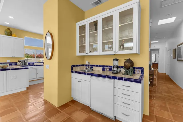 a bedroom with a bed and painting on the wall