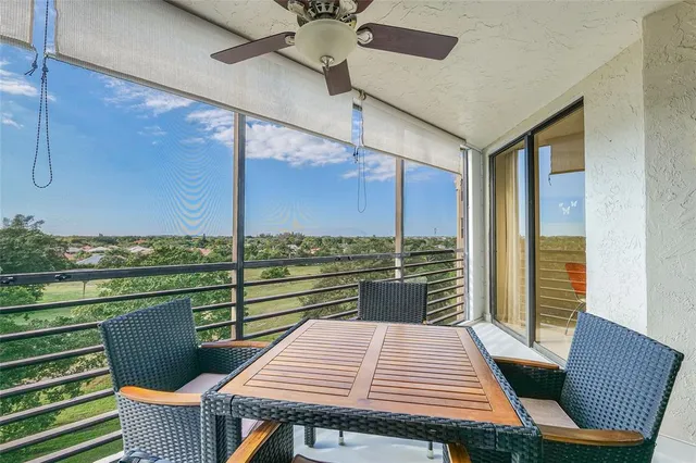 a view of a balcony with a table and chairs