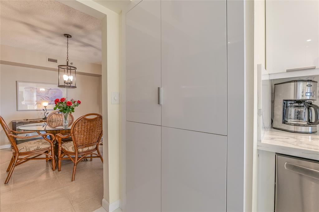 7200 Radice Court, Unit 705 Lauderhill, FL 33319 - Photo 12 of 54 a dining room with furniture and a chandelier fan