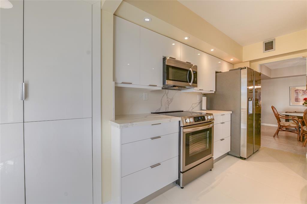 7200 Radice Court, Unit 705 Lauderhill, FL 33319 - Photo 13 of 54 a kitchen with a stove microwave and refrigerator