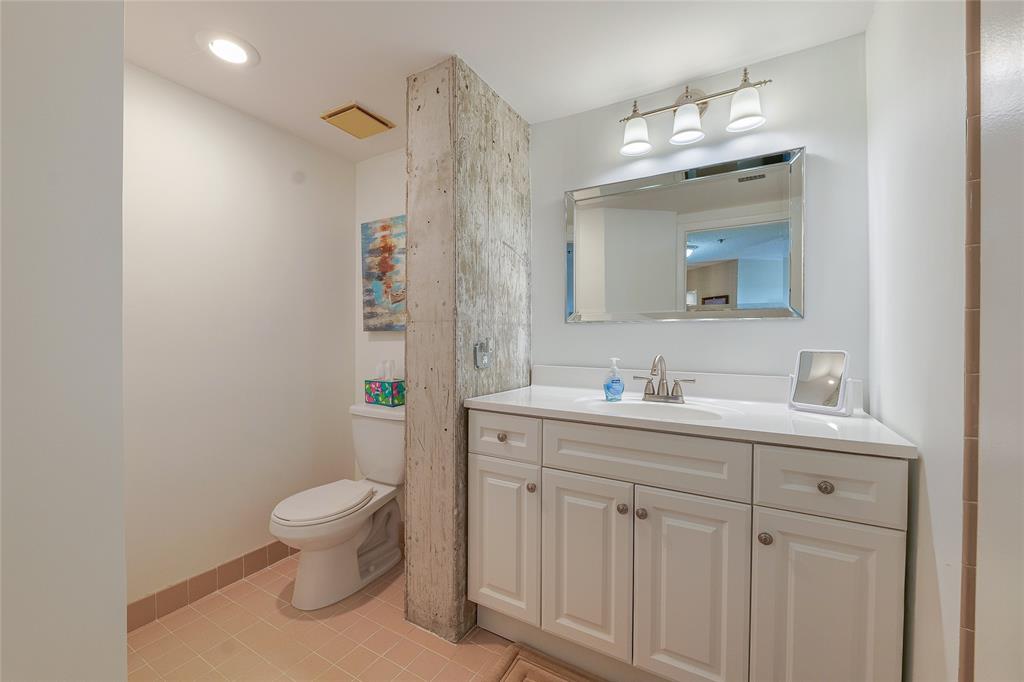 7200 Radice Court, Unit 705 Lauderhill, FL 33319 - Photo 18 of 54 a bathroom with a toilet sink and mirror