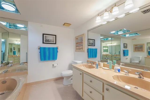 a bathroom with a bathtub a mirror a toilet and a sink