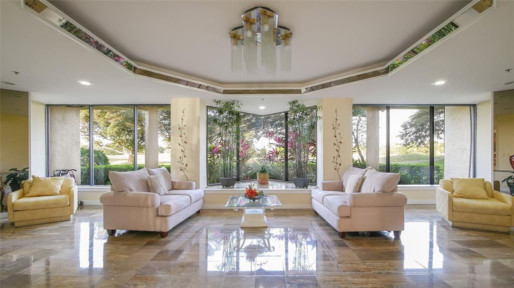7200 Radice Court, Unit 705 Lauderhill, FL 33319 - Photo 49 of 54 a living room with furniture and a large window