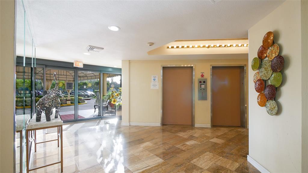 7200 Radice Court, Unit 705 Lauderhill, FL 33319 - Photo 50 of 54 a view of a hallway with dining area and glass door